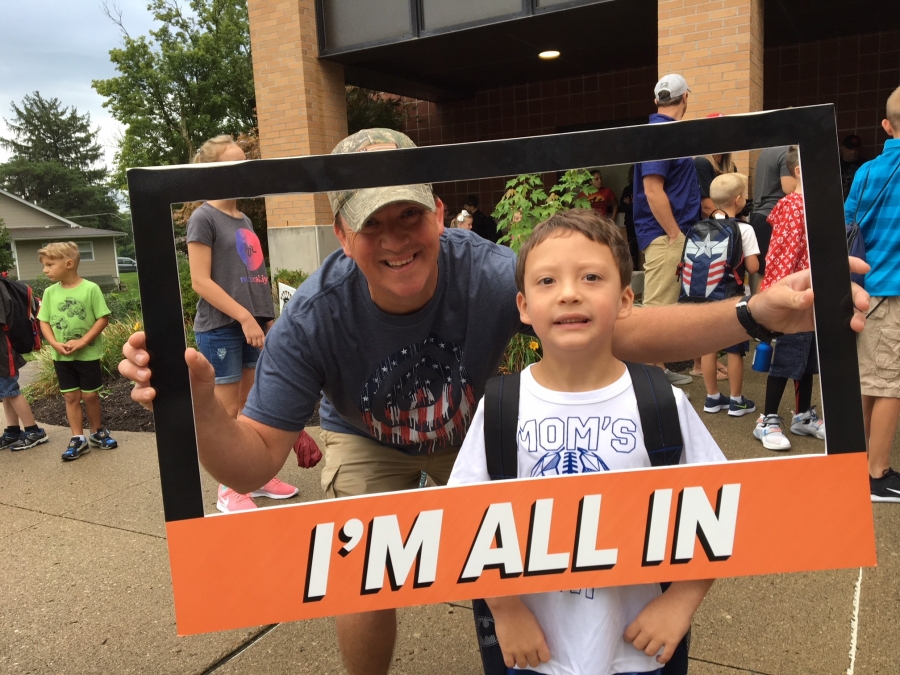 people holding a frame sign